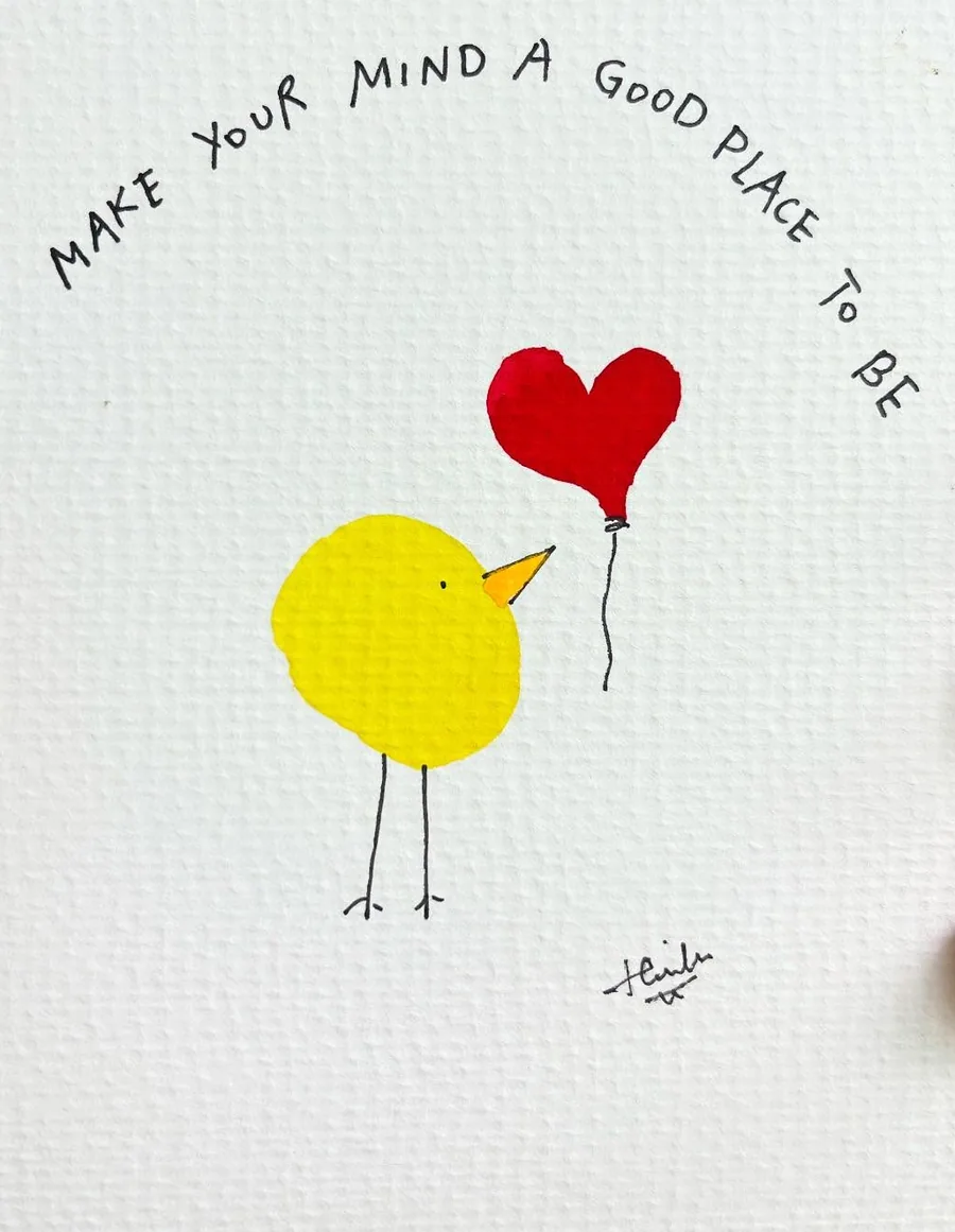 A small yellow bird holding a red heart balloon, lettered “Make your mind a good place to be”