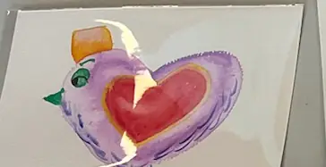 A watercolour bird painted around a large red heart