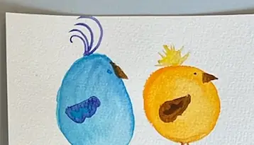 Two small round watercolour birds side by side, one blue and one yellow