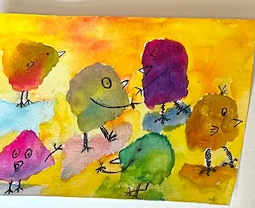 A flock of small bright watercolour birds on a yellow and orange wash